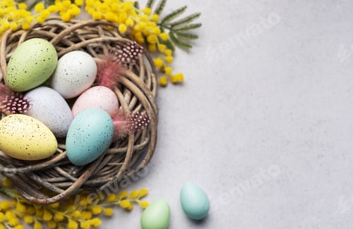 Preview: Colorful Easter Eggs Nestled in a Wicker Basket With Yellow Flowers on a Light Background