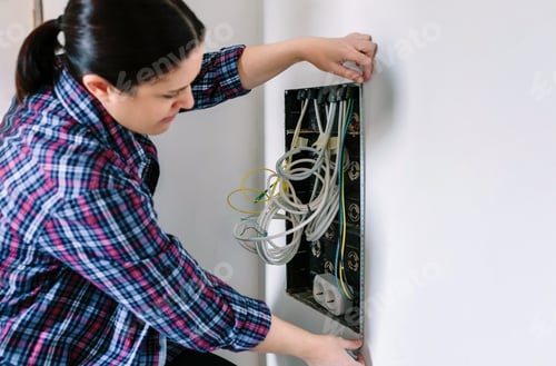 Preview: Female technician measuring telecommunication box