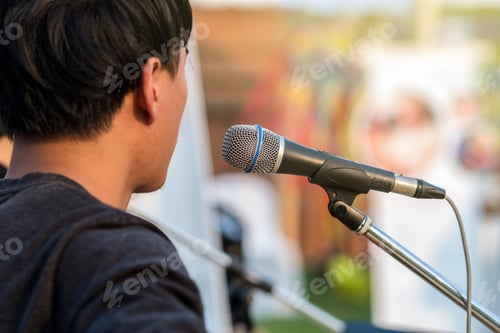 Preview: Microphone on the stage for artist sing a song over the Abstract blurred photo of audience