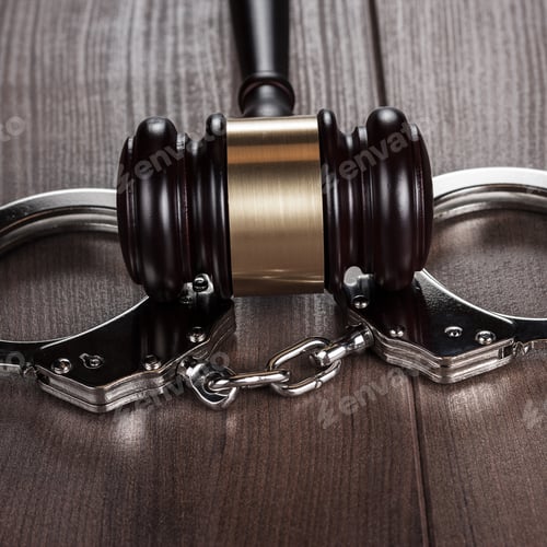 Preview: Handcuffs And Judge Gavel On Brown Wooden Table
