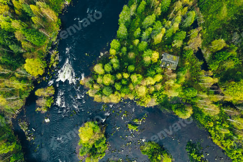Preview: Aerial view of fast river in beautiful green spring forest in Finland.
