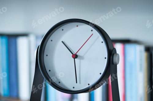 Preview: simple modern clock on a book shelf .