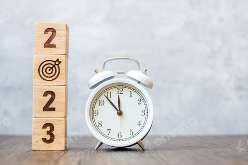 Preview: Happy New Year with vintage alarm clock and 2023 block with dart icon.