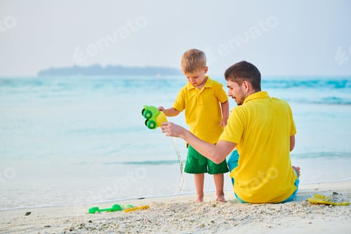 Preview: Toddler boy on beach with father