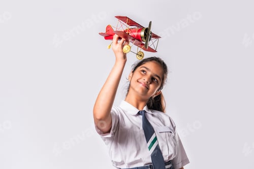 Preview: Indian asian cute little school kid studying aeroplane with a model plane