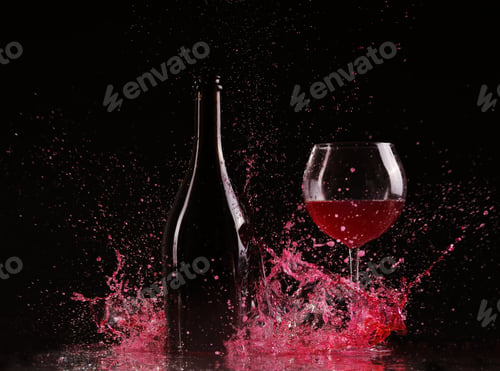 Preview: Glass and bottle of red wine splash on black