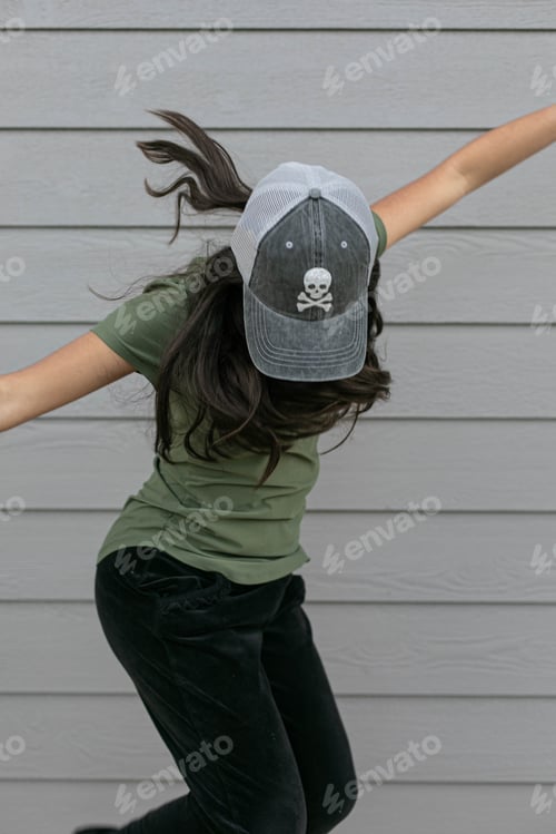 Preview: Girl jumping wearing a black hat
