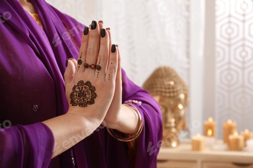 Preview: Woman with henna tattoos on hands indoors, closeup and space for text. Traditional mehndi ornament