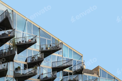 Preview: Low angle shot of a modern building with balconies full of different kinds of plants