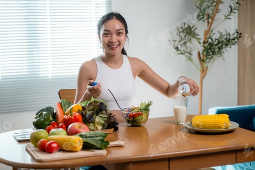 Preview: Young woman pouring milk into glass, eating healthy food at home