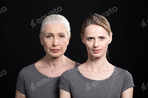 Preview: serious women looking at camera, young and senior people isolated on black