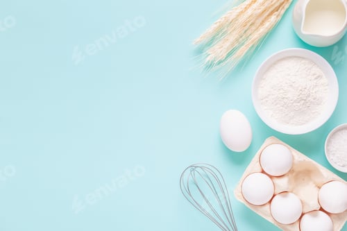 Preview: Ingredients for baking on light blue background.