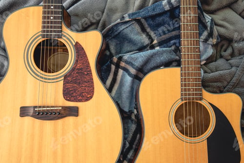 Preview: Two acoustic guitars on a cozy plaid, top view.