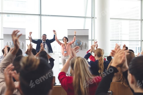 Preview: Diverse business people applauding at business seminar in office building