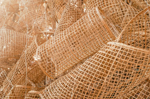 Preview: A collection of bamboo fish traps intricately arranged, showcasing traditional craftsmanship.