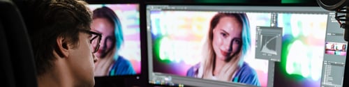 Preview: Back view of a young white man video editor