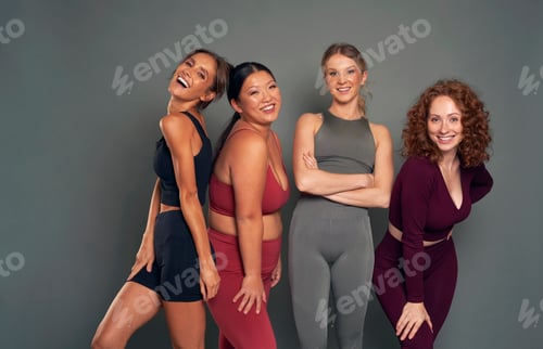 Preview: Four confident young women in sports clothes in studio shot