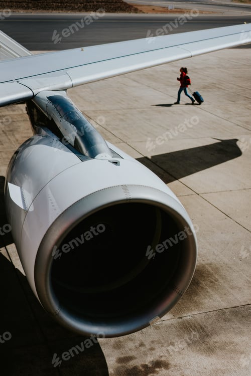 Preview: Turbine of engine airplane. Traveler with luggege in the background