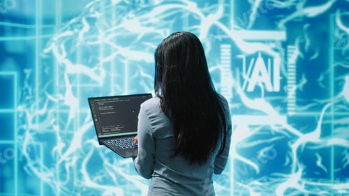 Preview: Computer scientist working on laptop, programming artificial intelligence