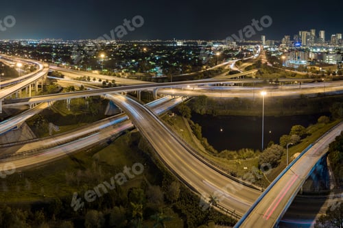 Preview: Aerial view of american highway junction at night with fast driving vehicles in Miami