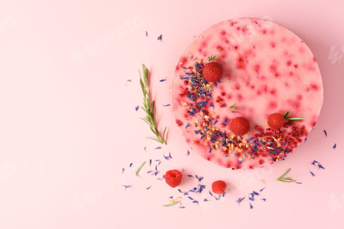 Preview: Delicious raspberry cake with fresh berries, rosemary and dry flowers on pink background. Copy space