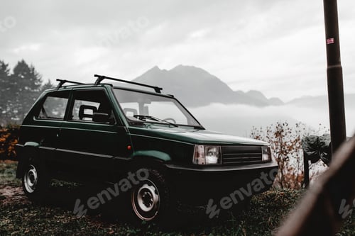 Preview: Retro car on shore of lake near hills