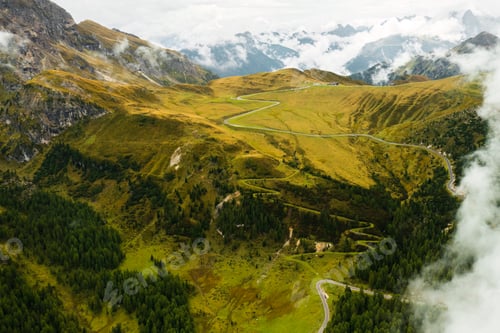 Preview: Surreal ambiance of the Dolomite Alps as clouds descend upon the valley.