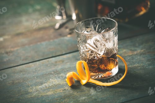 Preview: Alcoholic cocktail with orange peel and ice