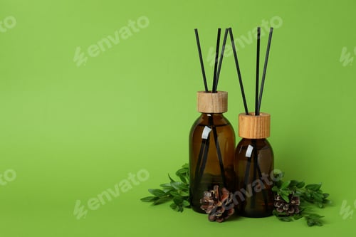 Preview: Aroma scent diffusers, cones and leaves on green background
