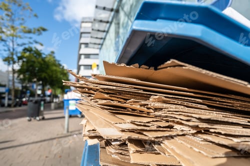 Preview: Used cardboard boxes to be collected in a plastic container for paper waste separation recycling.