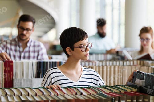 Preview: Woman reading a book at the library