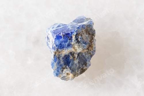 Preview: sample of raw benitoite mineral on white marble