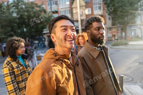 Preview: Group of young people walking and talking on city street