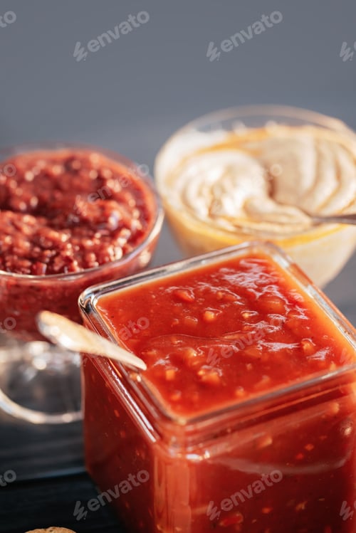 Preview: Hot chili pepper sauce paste harissa close up.