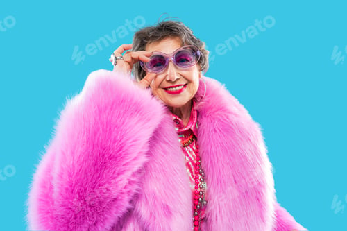 Preview: Happy and funny senior old woman on colorful background