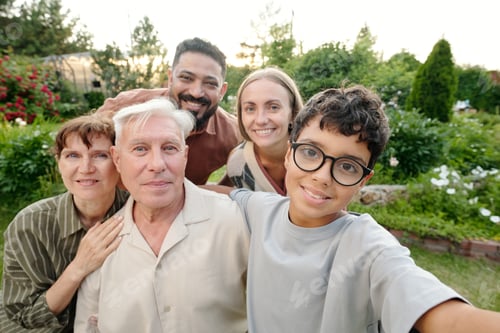 Preview: Multiethnic Family Group Smiling and Posing Together Outdoors in Garden