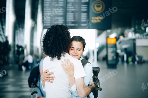 Preview: Young couple at the airport departure area saying goodbye