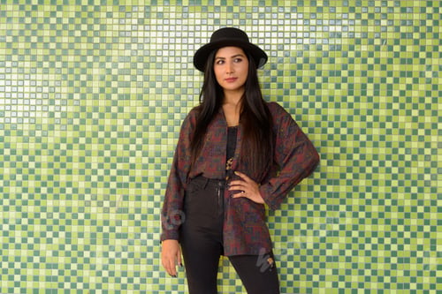 Preview: Portrait of beautiful young woman against colorful wall