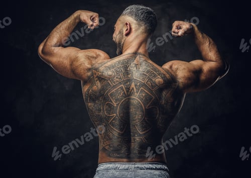 Preview: Adult caucasian muscular bodybuilder in a studio