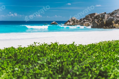 Preview: Grand Anse beach, with blue colored deep waves at La Digue Island, Seychelles