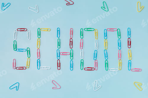 Preview: Paperclip on blue background, lettering that Back to school concept.