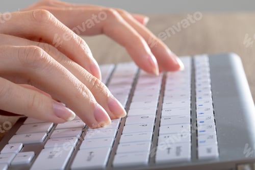 Preview: Close up of caucasian businesswoman typing on keyboard, isolated on grey background