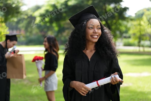 Preview: graduates in caps and gowns beam with joy, embracing and cheering in celebration.