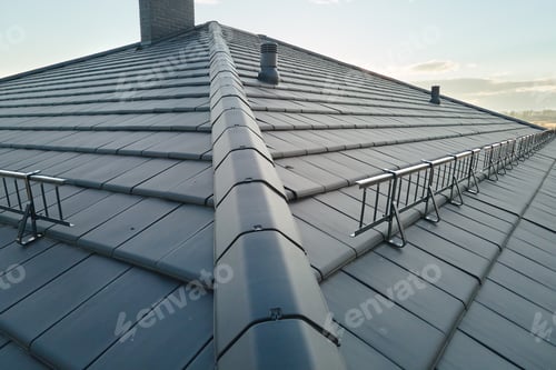 Preview: Closeup of house roof top covered with ceramic shingles. Tiled covering of building