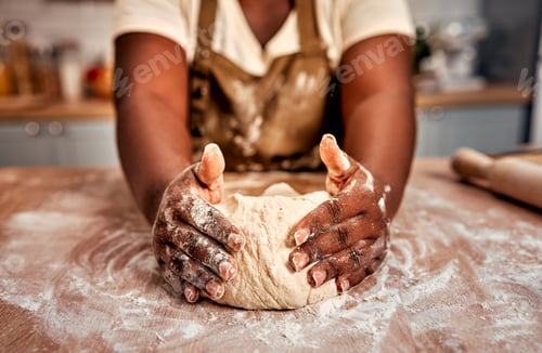 Preview: Details in baking process. Close up of black female hands molding raw dough on wooden table powdered