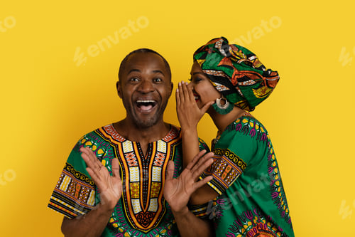 Preview: Black woman sharing secrets with husband, african couple on yellow