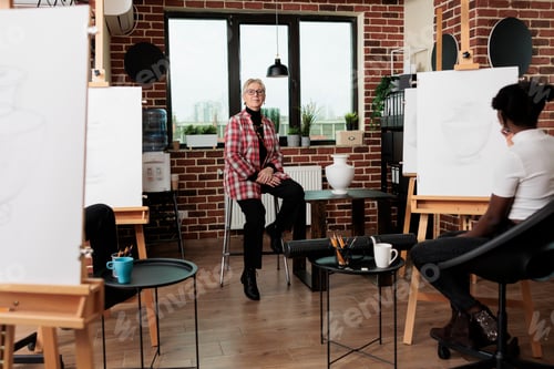 Preview: Art teacher during drawing lesson