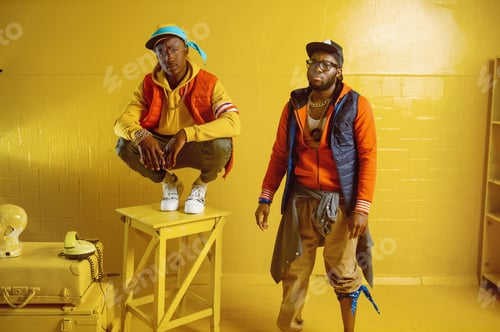 Preview: Two stylish rappers in studio, yellow background