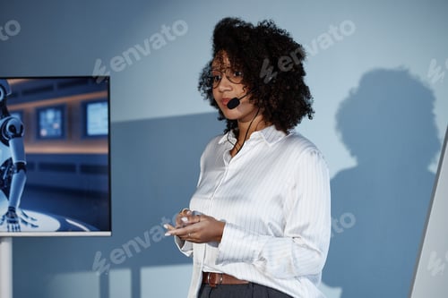 Preview: Black Female Speaker with Mic Presenting AI Technologies at Business Forum