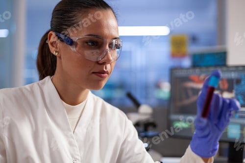 Preview: Biologist doctor holding transparent test tube with blood sample analyzing dna expertise